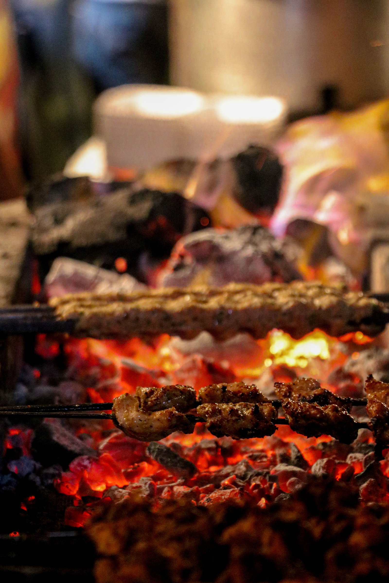 Yakitori skewers grilling above glowing Binchotan embers